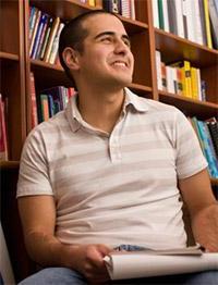 Student in library with book.